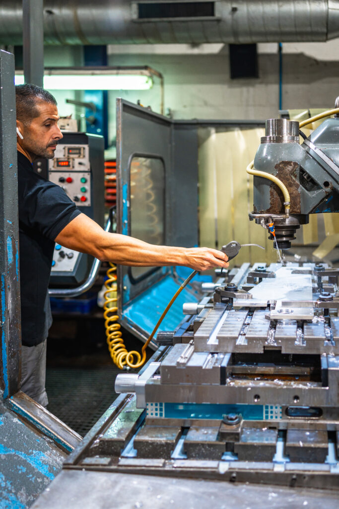 worker using electric milling machine in an innovative factory